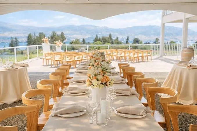 Wedding reception table set under a tent at Averill Creek Vineyard in Duncan, BC, with valley views