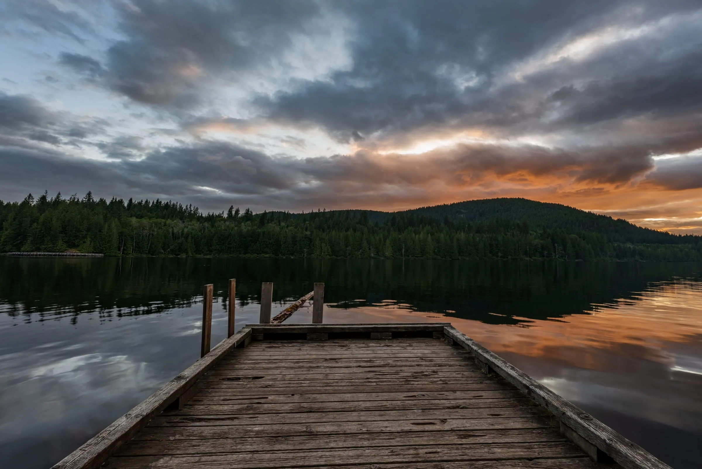 Wooden dock on Cowichan Lake at sunset in Lake Cowichan, BC, near lakeside wedding and event venues